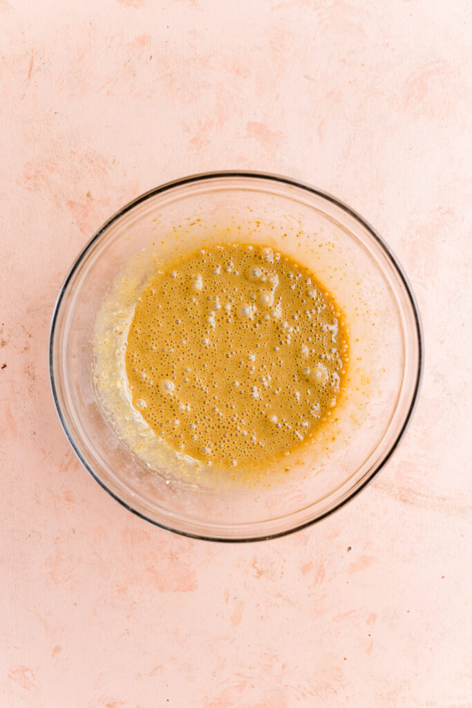 Wet ingredients in a glass mixing bowl.