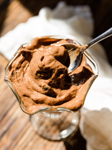 Spoon scooping out creamy chocolate nice cream.