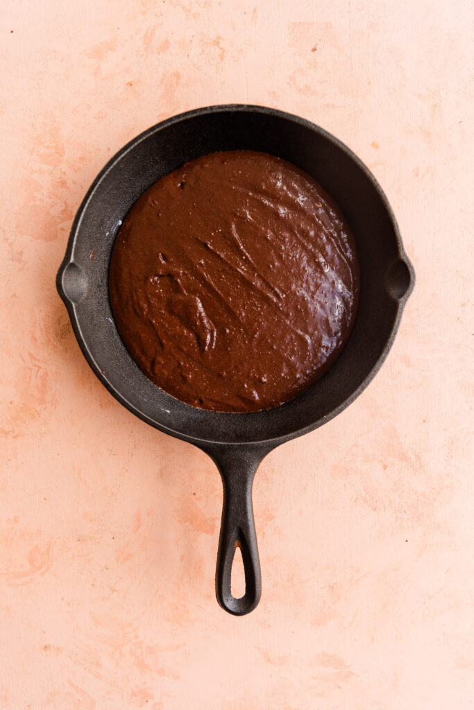 Brownie batter in cast iron skillet.