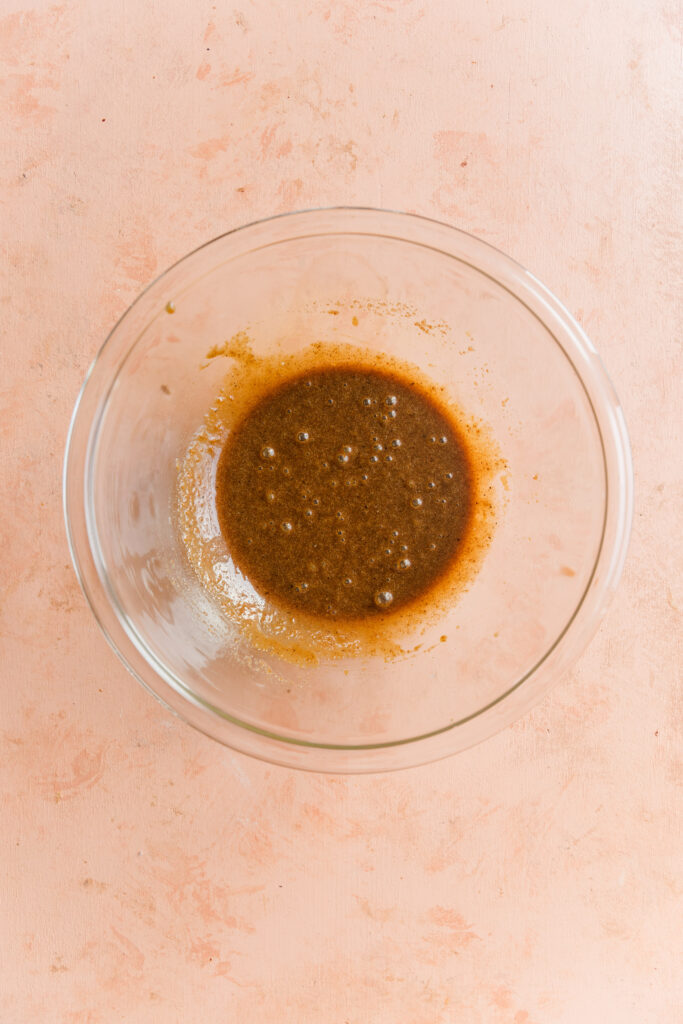 Wet ingredients in glass mixing bowl.