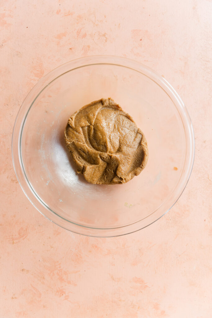 Cookie dough in glass mixing bowl.