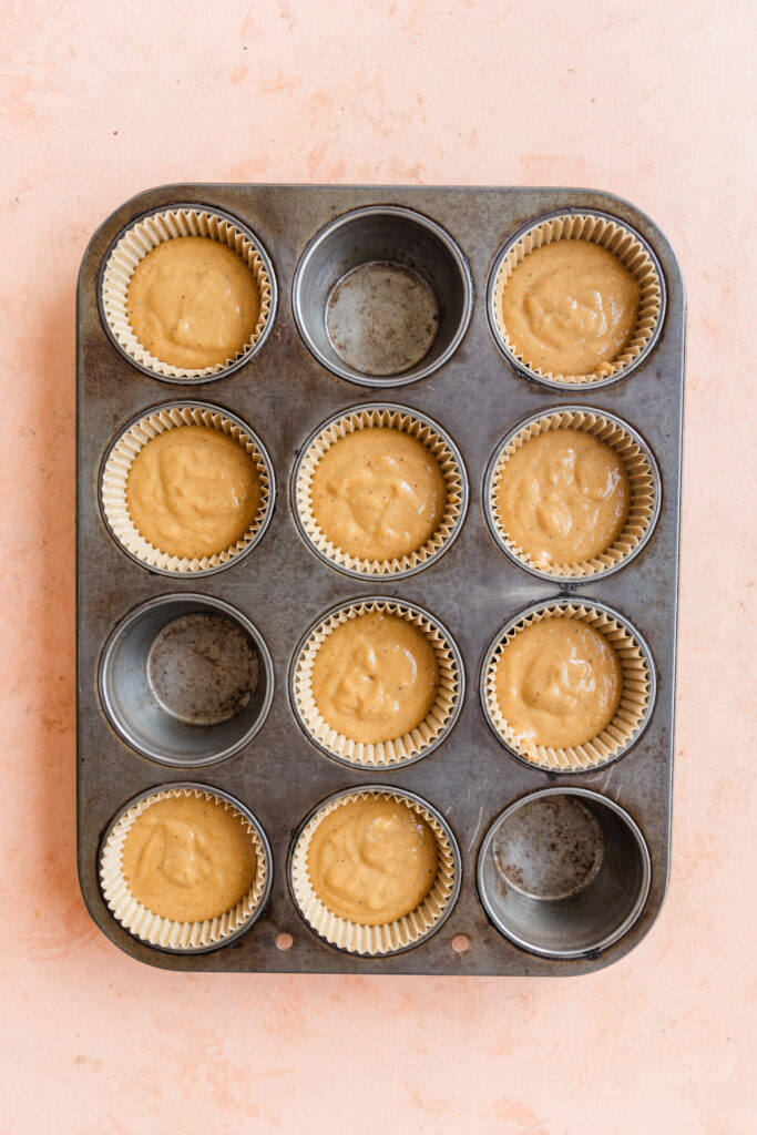 9 vanilla cupcakes in cupcake pan before baking.