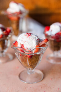 Healthy Strawberry shortcake cup with vanilla cake, fresh coconut whipped cream, and strawberries.