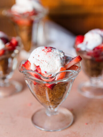 Healthy Strawberry shortcake cup with vanilla cake, fresh coconut whipped cream, and strawberries.