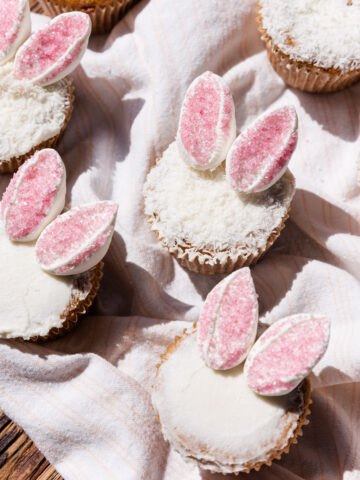 Vanilla cupcakes frosted with vanilla frosting and topped with marshmallow bunny ears.