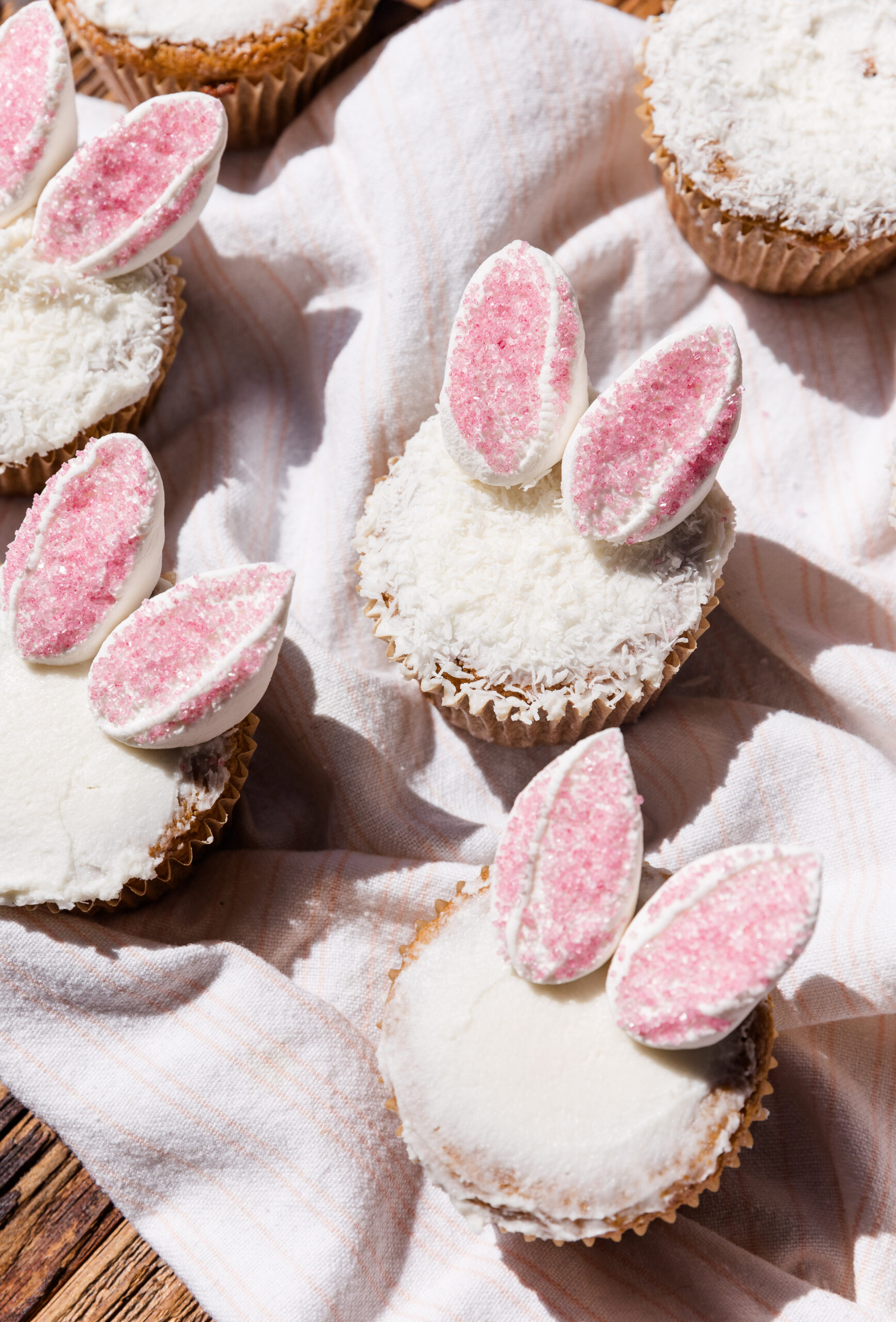 Vanilla cupcakes frosted with vanilla frosting and topped with marshmallow bunny ears.