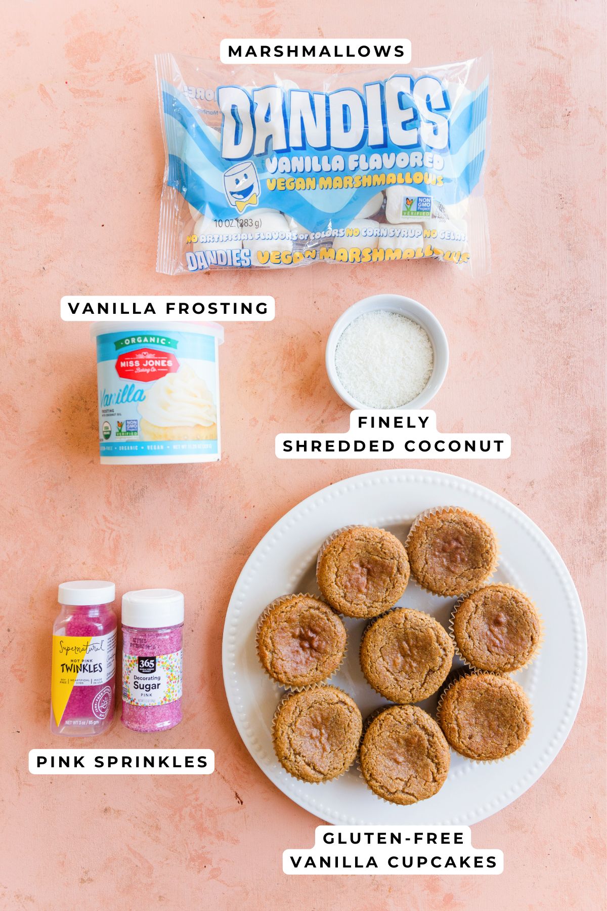 Marshmallows, pink sprinkles, vanilla cupcakes, vanilla frosting, and shredded coconut for bunny ear cupcakes.