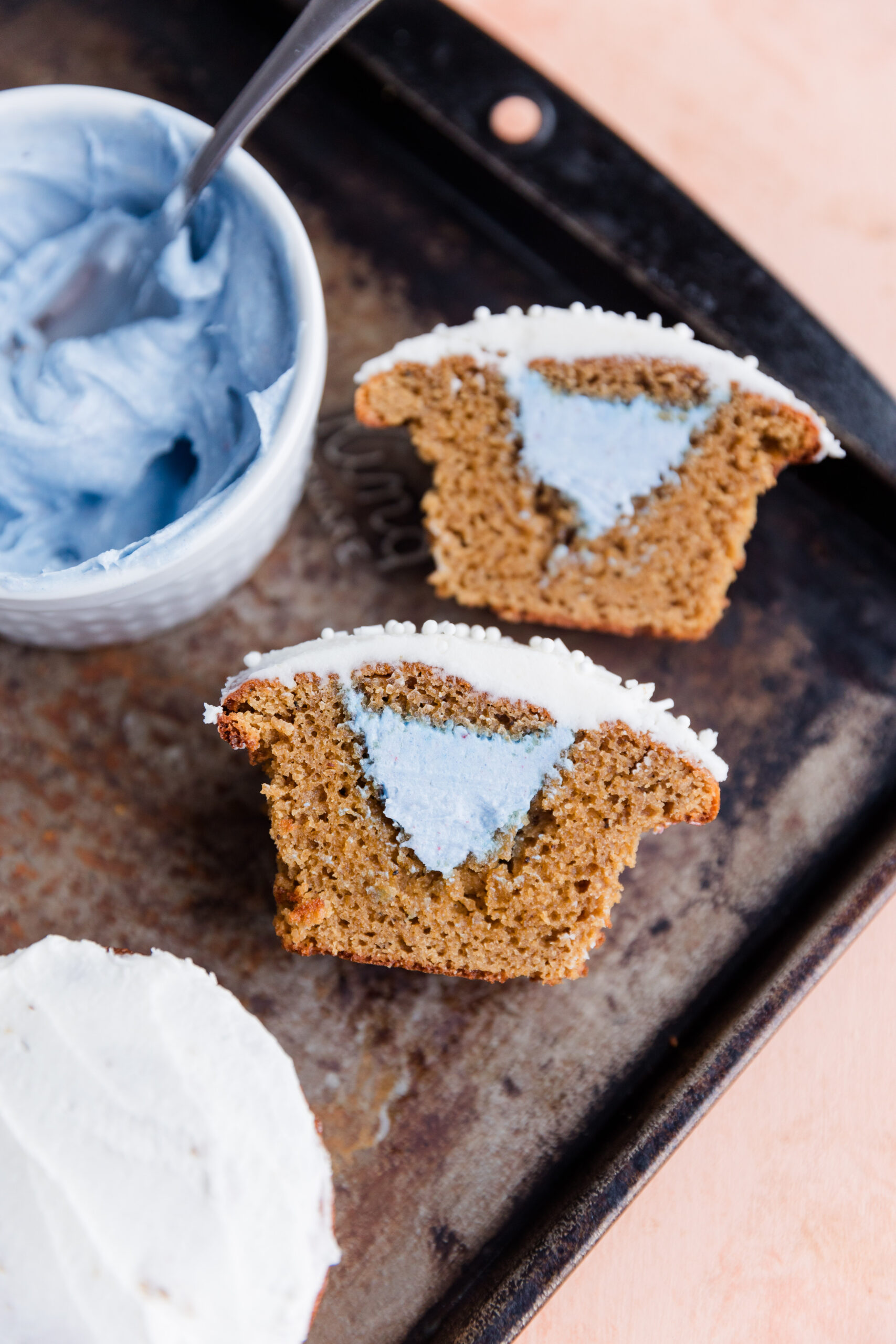 Blue frosting filled vanilla cupcakes.