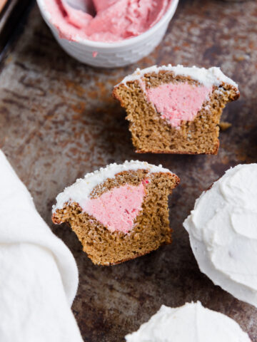 Pink gender reveal vanilla cupcakes.