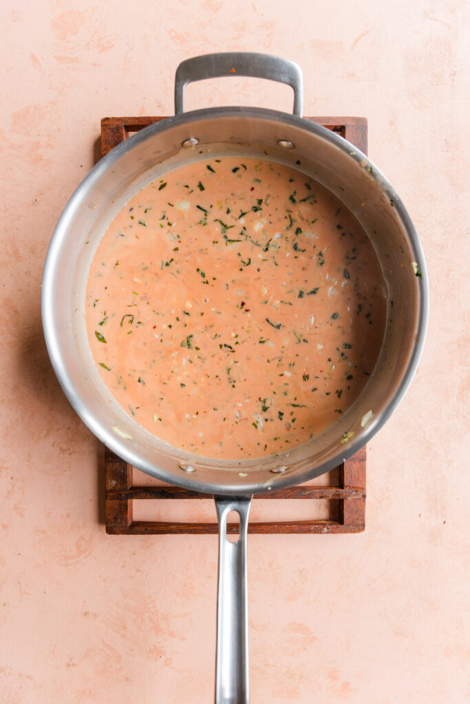 Pink sauce with full fat coconut milk, tomato paste, and onion mixture before cooking.