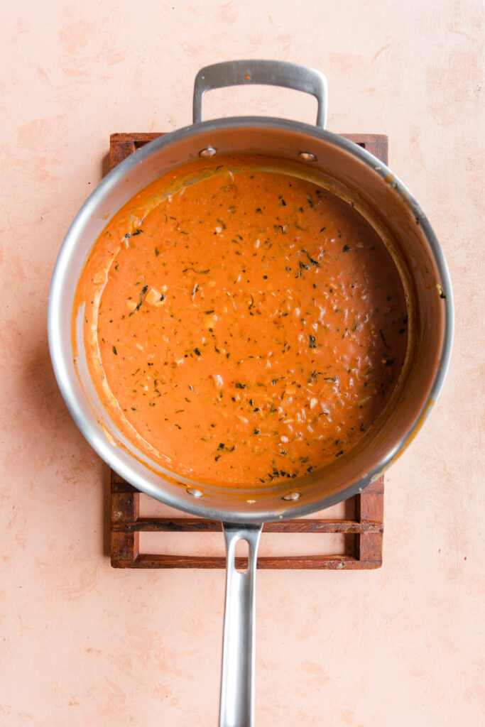 Cooked vegan pink sauce in large pan.