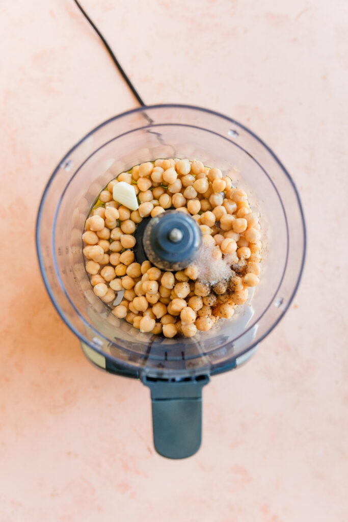 Homemade hummus ingredients in food processor.