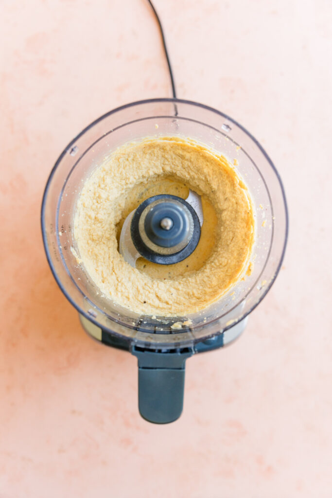 Creamy hummus in food processor.